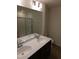 Bathroom featuring a double sink vanity, a large mirror, and a glass enclosed shower at 28 Longdale Dr, Graham, NC 27253