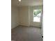 Bright bedroom featuring neutral carpet and natural light from a window overlooking the backyard at 28 Longdale Dr, Graham, NC 27253