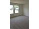 Bedroom with neutral carpet, two windows offering natural light, and a view of the outdoors at 28 Longdale Dr, Graham, NC 27253
