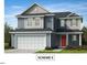 Charming two-story home boasts a classic design with a red front door and a two-car garage at 28 Longdale Dr, Graham, NC 27253