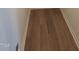 Hallway featuring hardwood floors and white trim at 28 Longdale Dr, Graham, NC 27253