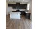 Open kitchen featuring dark brown cabinets, stainless steel appliances, white countertops and an island at 28 Longdale Dr, Graham, NC 27253