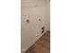 Laundry room area featuring hardwood floors and utility hookups at 28 Longdale Dr, Graham, NC 27253