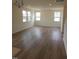 Bright, spacious living room with hardwood floors and large windows at 28 Longdale Dr, Graham, NC 27253