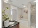 Bathroom with a granite-top vanity, a bathtub, and a shower with glass door at 301 Fayetteville St # 3205, Raleigh, NC 27601