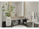 The bathroom features a dark granite vanity, decorative plant and towel, with framed mirror at 301 Fayetteville St # 3205, Raleigh, NC 27601