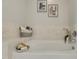 Bright bathtub with textured tile, brushed-metal fixtures, and modern decor accents at 301 Fayetteville St # 3205, Raleigh, NC 27601