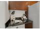 Functional desk space area featuring granite countertop and wood cabinets for organized storage at 301 Fayetteville St # 3205, Raleigh, NC 27601