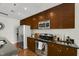 Kitchen features stainless steel appliances, granite countertops, and rich wood cabinets at 301 Fayetteville St # 3205, Raleigh, NC 27601