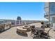 Rooftop patio featuring a built-in grill, fire pit, and comfortable seating for outdoor entertaining at 301 Fayetteville St # 3205, Raleigh, NC 27601
