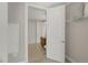 A walk-in closet with white door, wire shelving, and a glimpse into the adjacent bathroom at 301 Fayetteville St # 3205, Raleigh, NC 27601