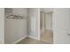 A walk-in closet with wire shelving, and a peek into the bathroom with tub and shower at 301 Fayetteville St # 3205, Raleigh, NC 27601