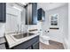 This bathroom is equipped with storage, a sink, and white tiling at 307 S Main St, Four Oaks, NC 27524
