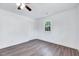 A cozy bedroom with wood-look flooring and natural light from a window at 307 S Main St, Four Oaks, NC 27524