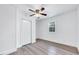 Bright bedroom features a ceiling fan, wood-look flooring, and a window with natural light at 307 S Main St, Four Oaks, NC 27524