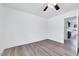 This bedroom features wood-look flooring and a doorway to a bathroom at 307 S Main St, Four Oaks, NC 27524