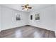 Spacious bedroom featuring wood-look flooring and bright windows at 307 S Main St, Four Oaks, NC 27524