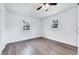 This bedroom features two windows and wood-look flooring at 307 S Main St, Four Oaks, NC 27524