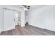 This bright bedroom has wood-look flooring, plus access to a bathroom and closet at 307 S Main St, Four Oaks, NC 27524