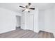 Bedroom featuring wood-look floors and access to a closet and adjacent room at 307 S Main St, Four Oaks, NC 27524