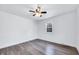 A cozy bedroom featuring wood-look flooring and a bright window at 307 S Main St, Four Oaks, NC 27524