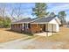 Cozy brick home with a covered carport, providing ample parking and protection from the elements at 307 S Main St, Four Oaks, NC 27524