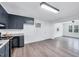 Spacious kitchen connected to another room, featuring stainless appliances and bright lighting at 307 S Main St, Four Oaks, NC 27524