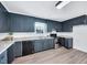 Well-lit kitchen featuring blue cabinets, stainless steel appliances, and durable countertops at 307 S Main St, Four Oaks, NC 27524