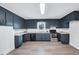 Well-lit kitchen featuring blue cabinets, stainless steel appliances, and durable countertops at 307 S Main St, Four Oaks, NC 27524