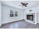 Bright living room with two large windows and a decorative fireplace at 307 S Main St, Four Oaks, NC 27524