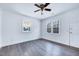 Cozy living room featuring a ceiling fan and two large windows for natural light at 307 S Main St, Four Oaks, NC 27524