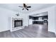 Open living room featuring a decorative fireplace and an adjoining, spacious kitchen at 307 S Main St, Four Oaks, NC 27524