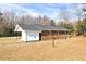 Brick home showcasing a cozy outdoor living space and a well-kept lawn, perfect for relaxation and entertaining at 307 S Main St, Four Oaks, NC 27524