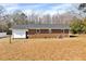 Exterior shot of the back of the home with a spacious backyard and classic brick architecture at 307 S Main St, Four Oaks, NC 27524