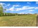 Large backyard with mature trees and a fence, creating a private and picturesque outdoor space for relaxation and recreation at 310 Mineral Spring Ln, Fuquay Varina, NC 27526