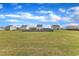 Large backyard featuring a spacious lawn, fenced perimeter and a view of neighborhood homes at 310 Mineral Spring Ln, Fuquay Varina, NC 27526