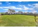 Expansive backyard with lush green grass, swing set, and privacy fence, perfect for outdoor activities at 310 Mineral Spring Ln, Fuquay Varina, NC 27526