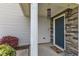Covered porch and front door framed by stone and featuring manicured landscaping at 310 Mineral Spring Ln, Fuquay Varina, NC 27526