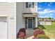 Inviting covered porch and front door framed by stone, manicured landscaping at 310 Mineral Spring Ln, Fuquay Varina, NC 27526