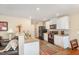 Bright kitchen featuring granite countertops, white cabinets, and wood-look flooring for modern appeal at 310 Mineral Spring Ln, Fuquay Varina, NC 27526