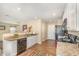 Bright kitchen with granite countertops, white cabinets, and modern appliances, perfect for cooking at 310 Mineral Spring Ln, Fuquay Varina, NC 27526
