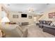 Large living room featuring a ceiling fan, plush carpeting, and abundant seating arrangements at 310 Mineral Spring Ln, Fuquay Varina, NC 27526