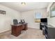 Home office provides a functional workspace with a large desk and plenty of natural light from the window at 310 Mineral Spring Ln, Fuquay Varina, NC 27526