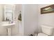 Charming powder room has a pedestal sink and a wall mirror, offering a convenient space for guests at 310 Mineral Spring Ln, Fuquay Varina, NC 27526