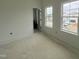 Bright bedroom with two windows and a doorway, painted in white at 4307 Emeline Way # 14, Fuquay Varina, NC 27526