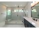 Bright bathroom with a frameless glass shower enclosure, white marble walls, and stylish vanity with dark fixtures at 4225 Burlington Mills Rd, Wake Forest, NC 27587