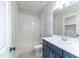 Bright bathroom with a white-tiled shower-over-tub and a modern vanity with ample storage at 4225 Burlington Mills Rd, Wake Forest, NC 27587