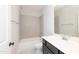 Bathroom featuring a white-tiled shower-over-tub and a modern vanity with ample storage at 4225 Burlington Mills Rd, Wake Forest, NC 27587