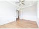 Bright bedroom with hardwood floors, paneled walls, a ceiling fan, and elegant French doors at 4225 Burlington Mills Rd, Wake Forest, NC 27587