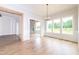 Bright dining area with large windows, hardwood floors, and stylish light fixture at 4225 Burlington Mills Rd, Wake Forest, NC 27587
